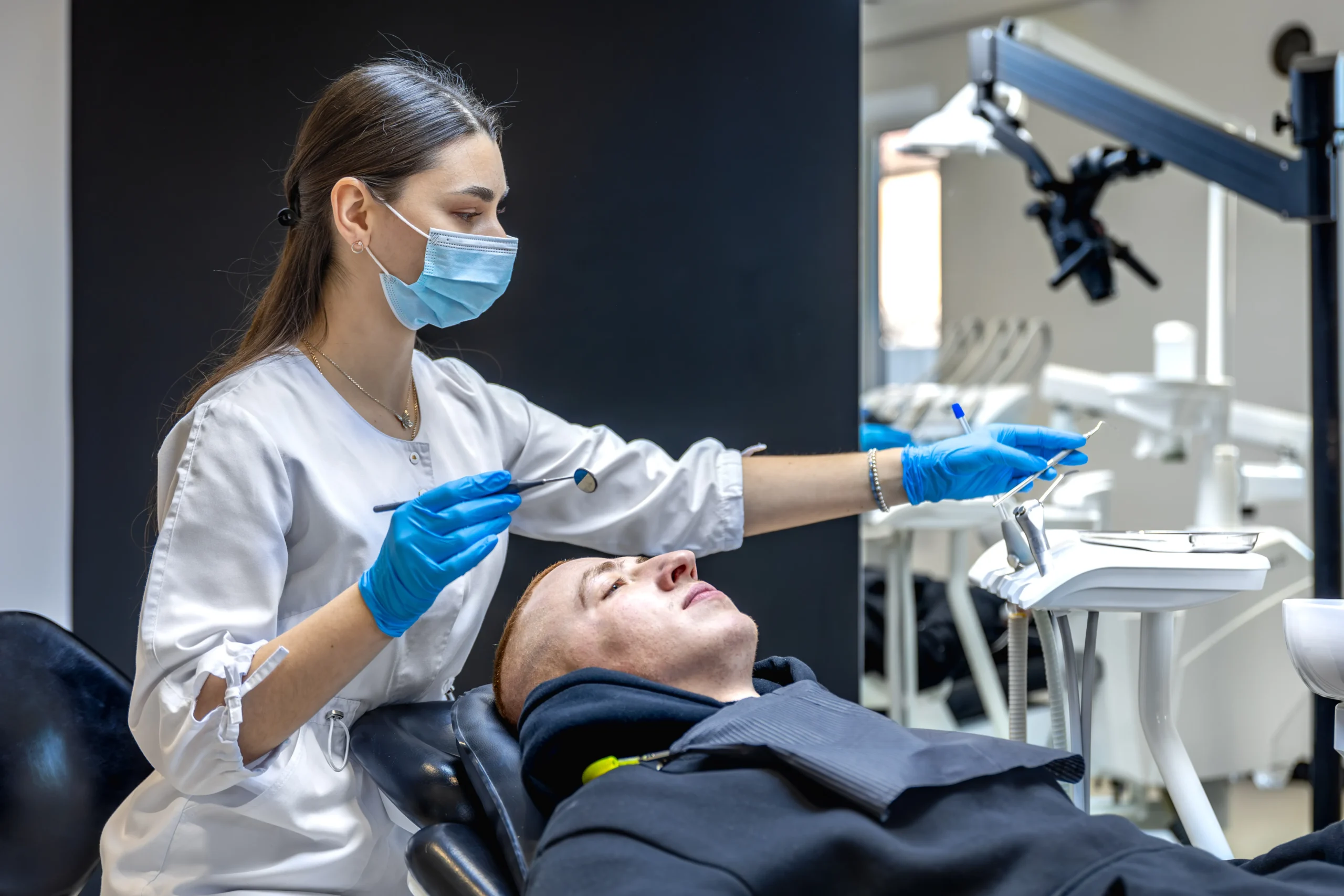 Patient receiving urgent dental consultation for a chipped tooth in a modern clinic